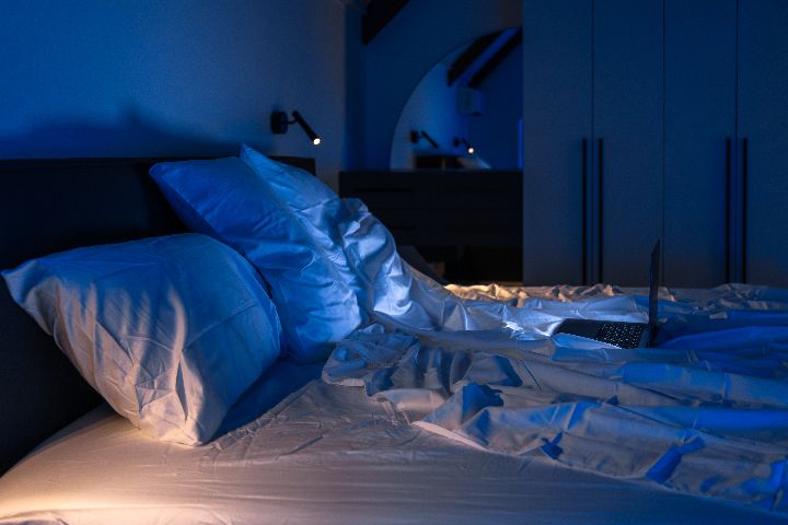 blue lit bedroom bed night