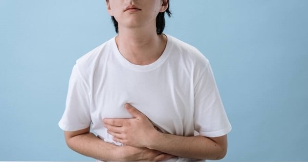 person holding their abdomen