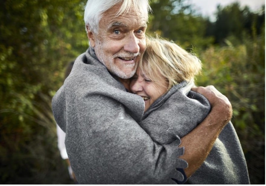 Man hugs woman