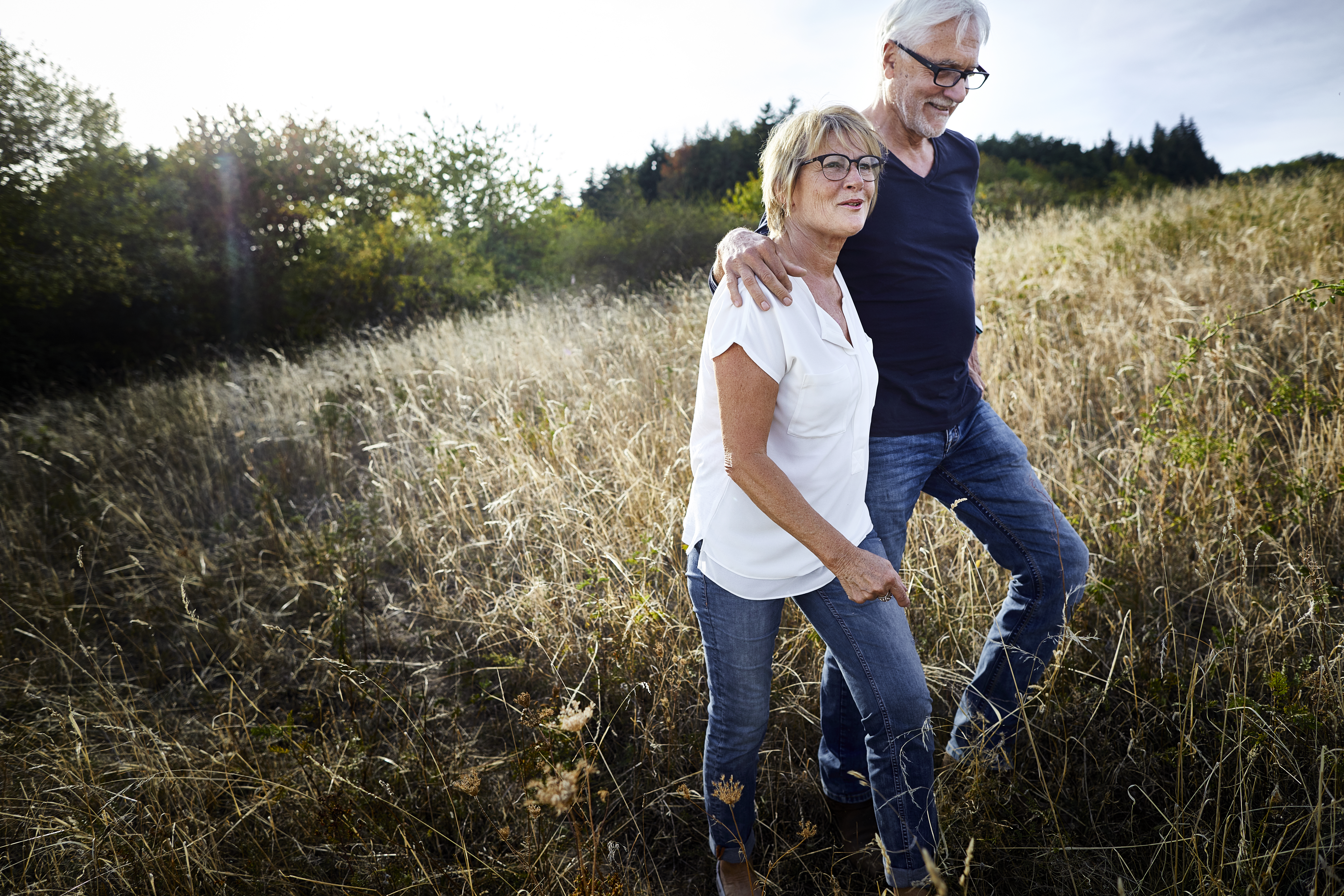 Couple Walking In A Field